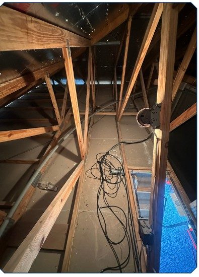 Attic before plywood decking in Cape Coral — bare joists with wiring exposed