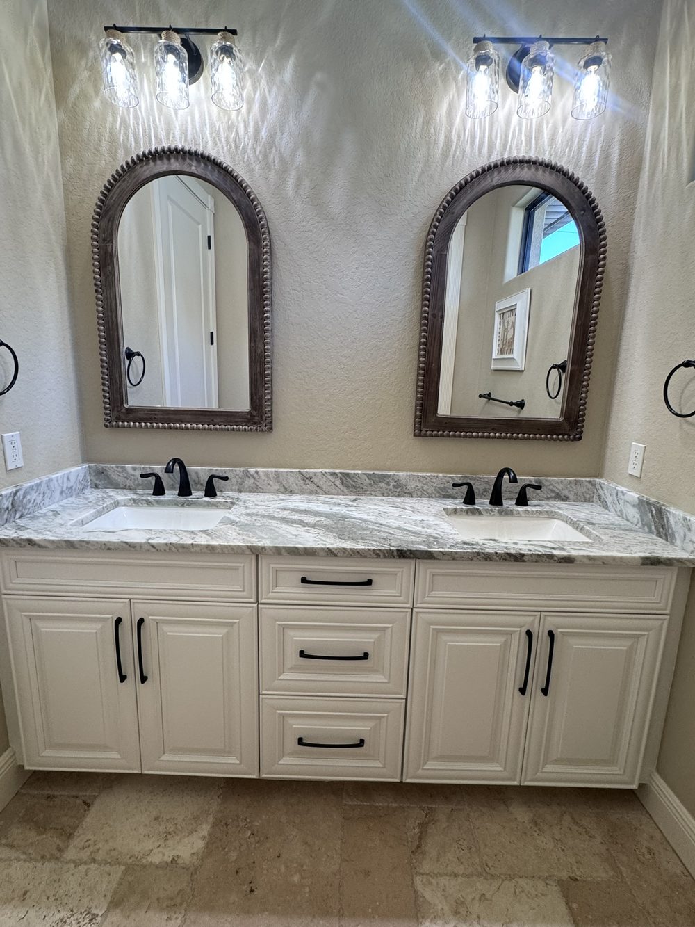 Bathroom vanity after cabinet painting in Cape Coral — cream painted cabinets
