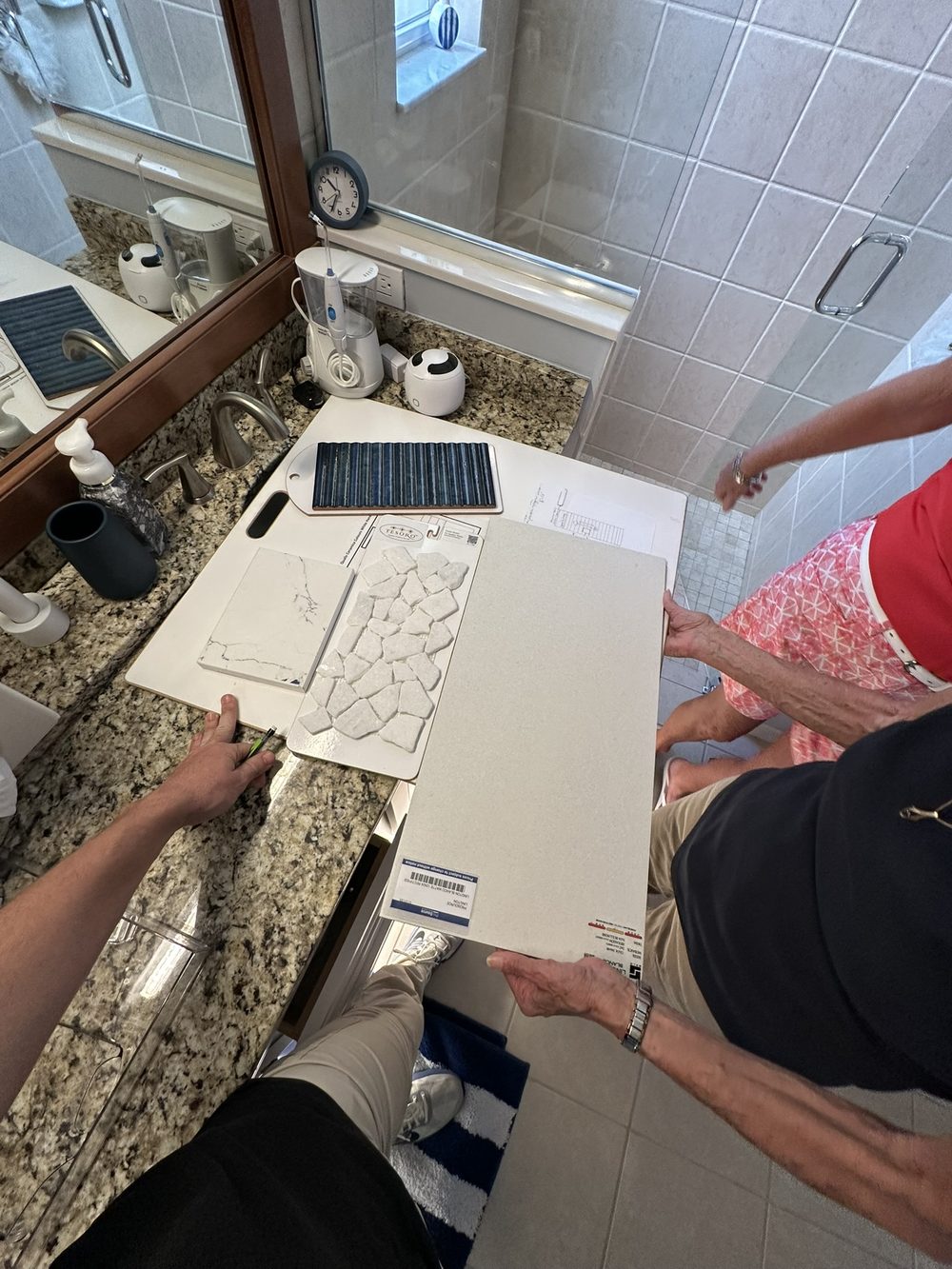 Bathroom before remodel — dated tan granite counters and material selection consultation