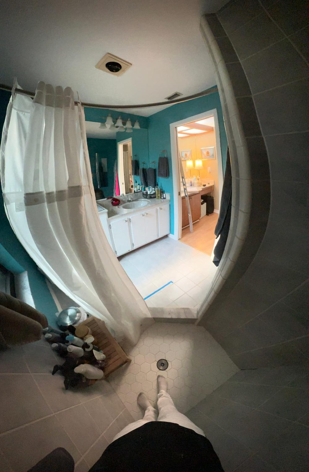 Bathroom before remodel — dated teal walls and beige tile