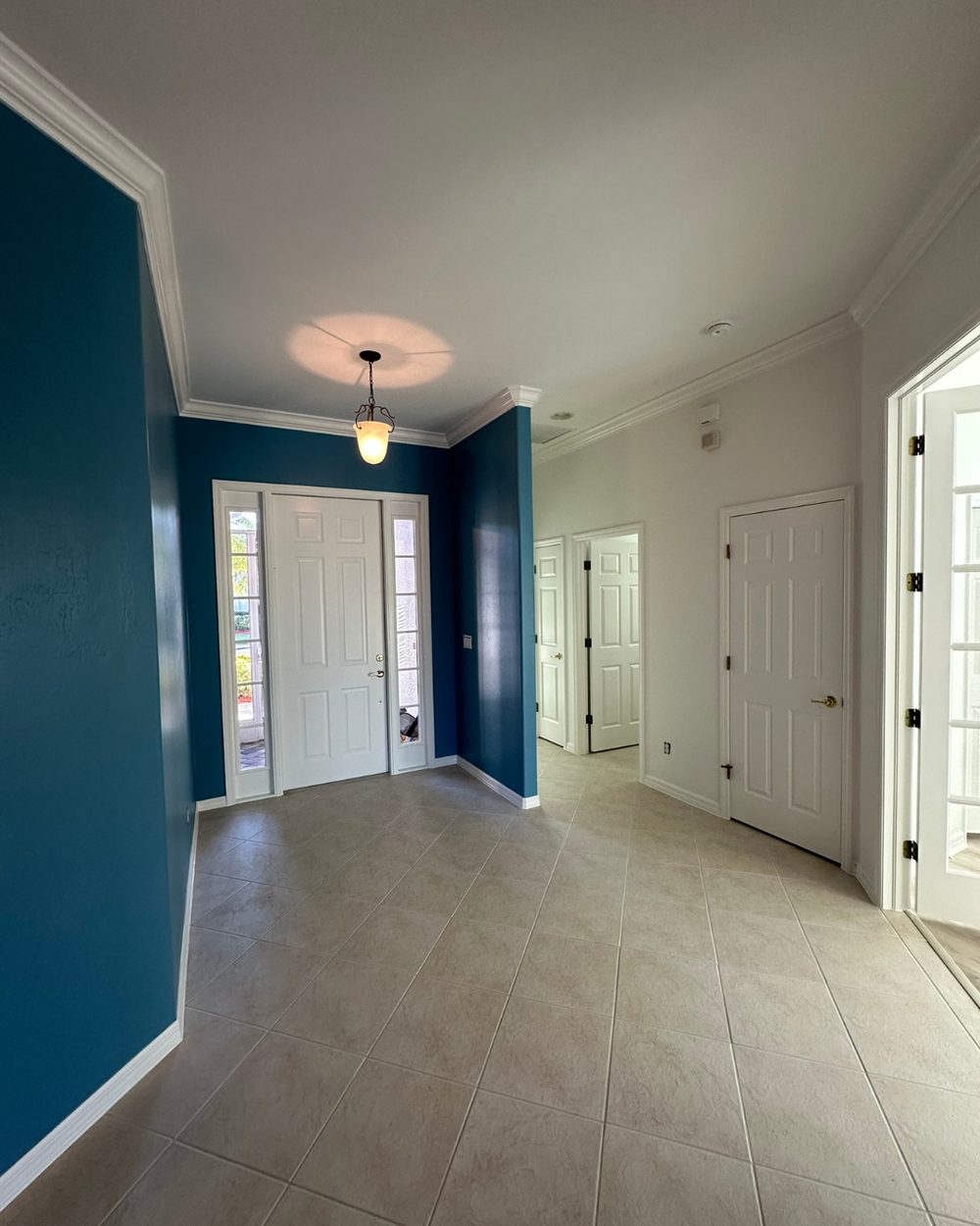 Entryway after painting — bold teal accent wall
