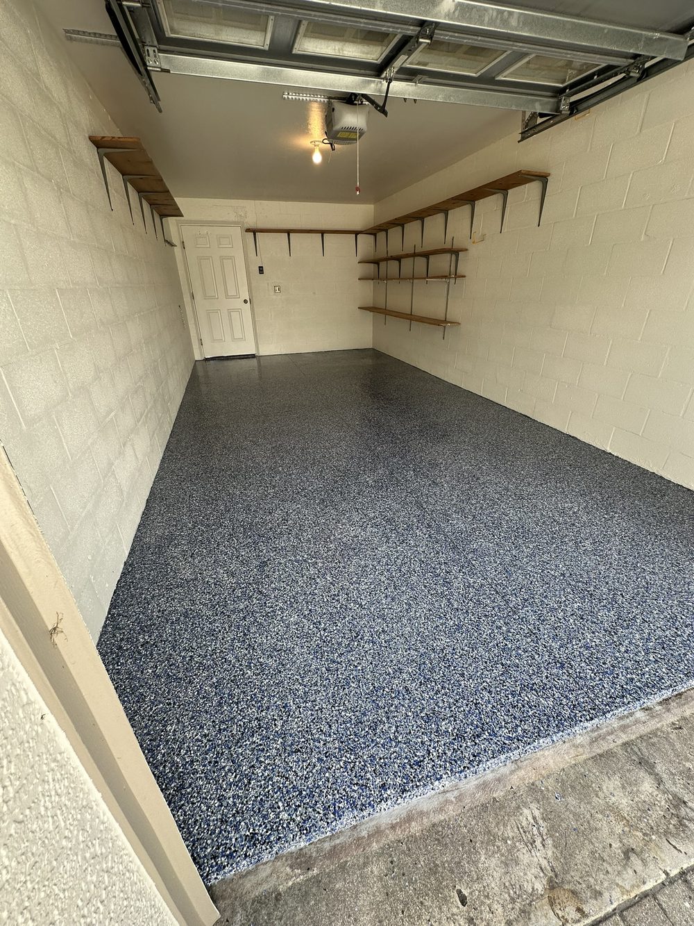 Garage floor after blue flake epoxy coating in Cape Coral