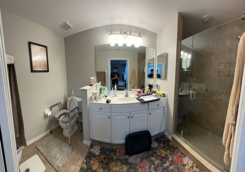 Master bathroom before remodel — dated tile and curved vanity