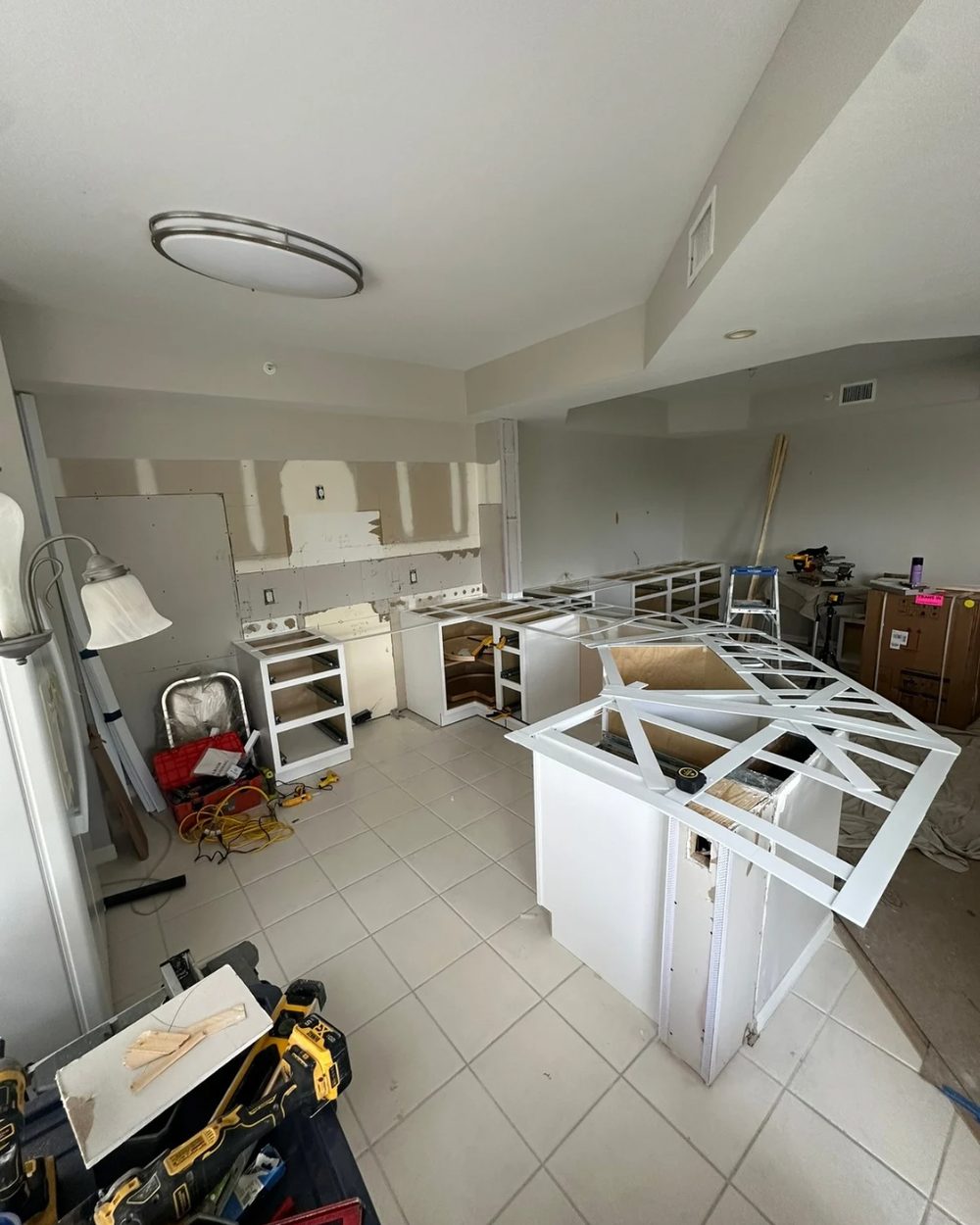 Kitchen before remodel — mid-construction with exposed drywall and unfinished cabinets