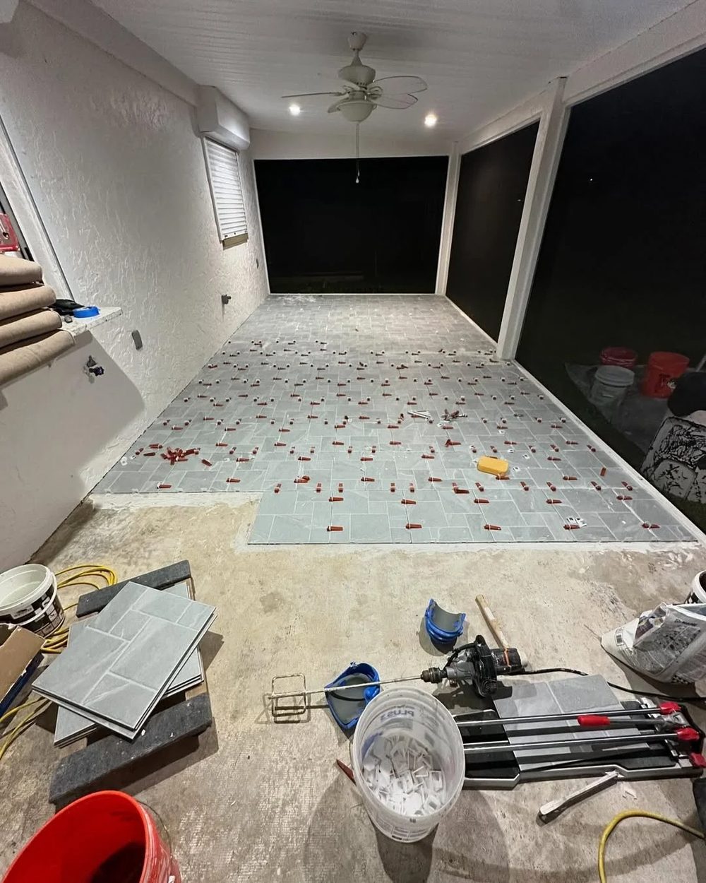 Lanai after tiling — new gray tile being installed