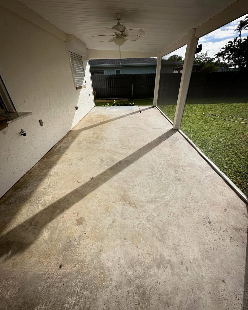 Lanai before tiling — bare stained concrete patio