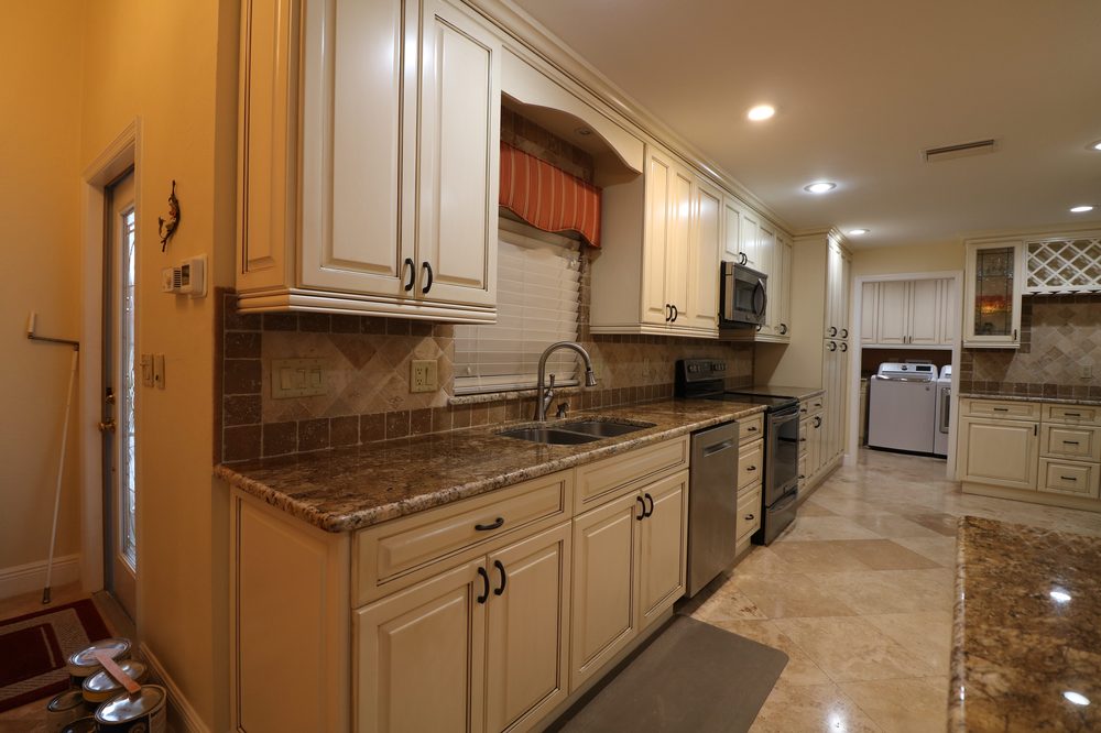 Kitchen with cream glazed cabinets and stone countertops