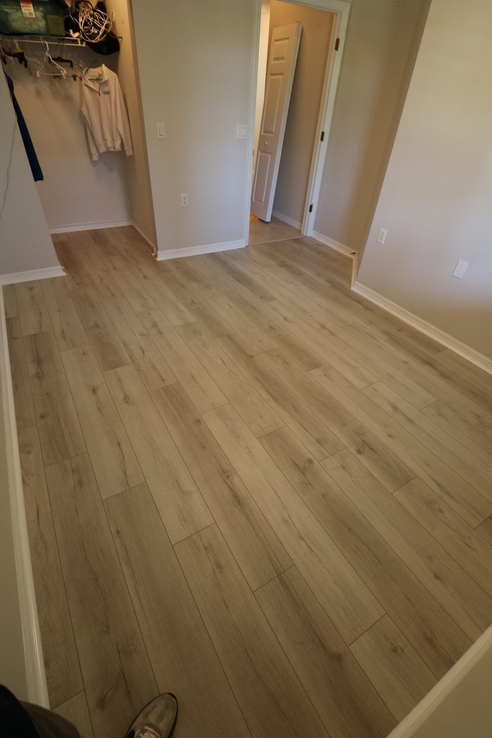Bedroom after flooring — new wood-look LVP flooring installed