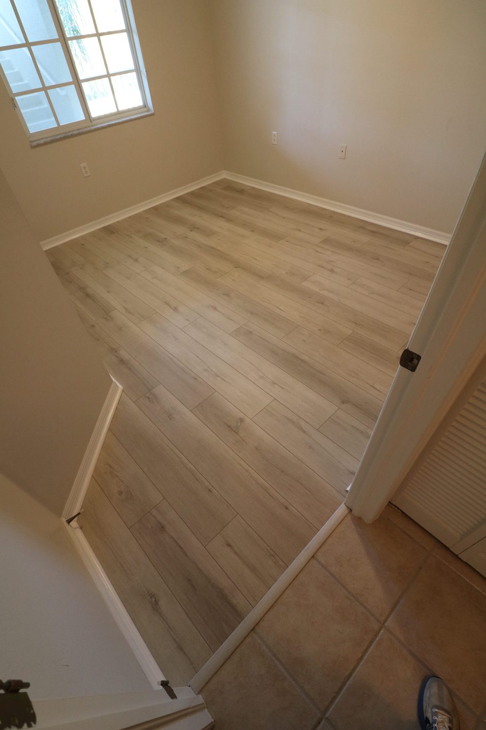 Room after LVP flooring installation — light gray wood-look luxury vinyl plank flooring